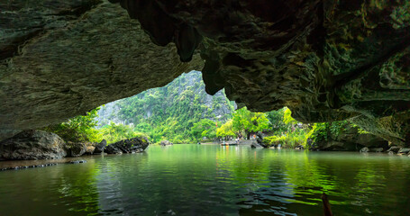Inside view out of natural cave in Tam Coc scenic spot, Ninh Binh, Vietnam. Asian natural cave