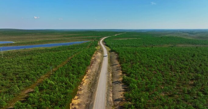 RV driving in middle of Kevo and Kaldoaivi wilderness nature, summer in Lapland - Aerial view
