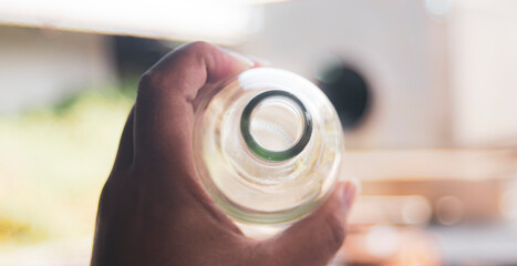 hand holding water glass bottle