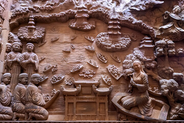 Stone carved base-relief of Ky Lan temple in Ninh Binh, Vietnam. Human figures and floral ornament bas-relief. Traditional Champa architectural details. Ancient building with stone carving decor