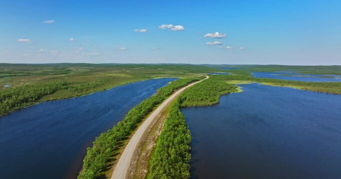 Drone shot of a road in middle of ponds in Kaldoaivi wilderness, summer in Lapland