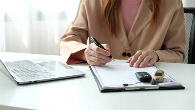 Customer hand-signed the insurance contract documentation agreement for commercial auto car loan buying or vehicle rental service.