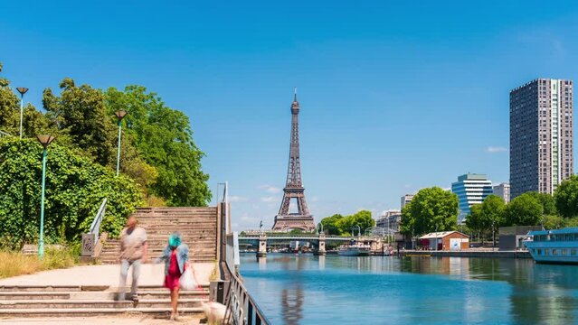 A timelapse of the Eiffel Tower along the river Seine with flyboats passing by with motion blur.Sunny but cloudy spring summer day paris city famous riverside bay tower view bridge timelapse panorama