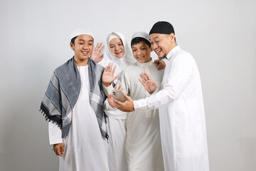 Happy muslim family making a video call or taking a selfie on Eid Mubarak moment