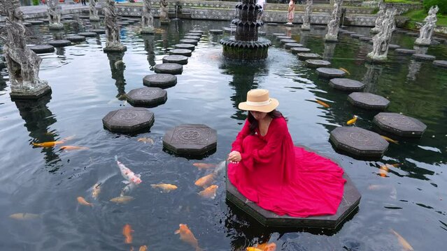 4K Slow video, Women tourists at Tirta Gangga Water Palace in Bali, Indonesia.