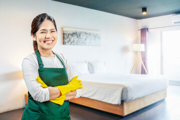 Asian housekeeper wear gloves apron