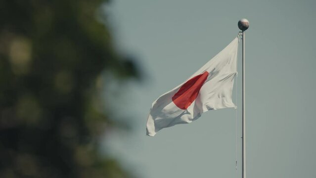 National Flag Of Japan Waving On A Windy Day In Tokyo, Japan. - closeup shot