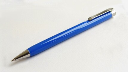 A blue pen with a silver clip sits on a white surface. The pen is sleek and modern, with a silver...