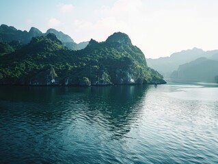 A beautiful mountain range with a lake in the foreground. The water is calm and clear, reflecting the mountains in the distance. The scene is peaceful and serene, with the mountains