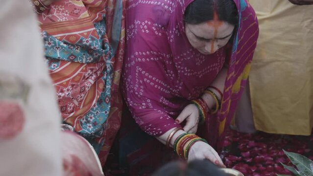 indian women praying to hindu almighty sun god at chhath festival