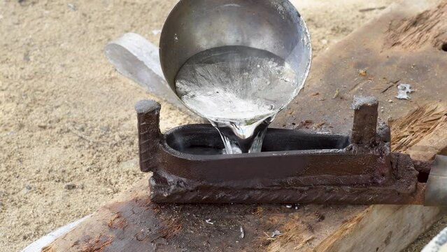Put liquid lead in mold that hardens soon to remove quickly, solid metal sinker close up