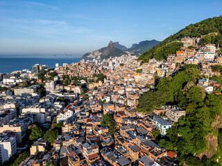 Aerial view of the buildings on steep slopes surrounding Ipanema Beach at sunrise. Morning light on...