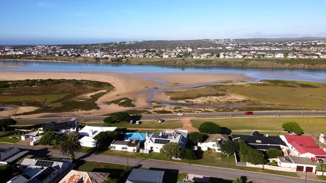 Aerial riser over Still Bay neighborhood reveals Goukou estuarine river