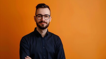 Obraz premium Portrait of Focused SQL Developer Posing Against Vibrant Orange Studio Background