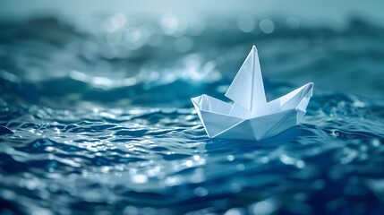 Origami boat sailing in blue ocean