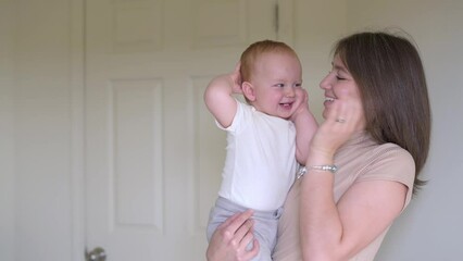 A heartwarming moment unfolds as a mother plays peekaboo with her delighted toddler, fostering joy and emotional bonding in a light-filled home environment.