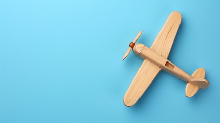 Naklejka premium Wooden toy airplane isolated on blue background
