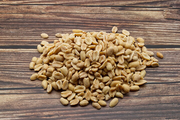 Pealed Peanuts isolated on wooden background
