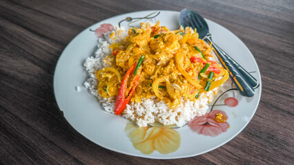 Stir-fried prawns with curry powder with fried egg rice, Thai food thai cuisine food on dish look good tase. wooen table 