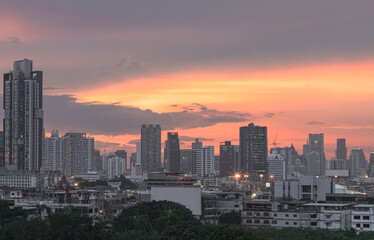 Fototapeta premium Bangkok city skyscrapers after sunset with Beautiful sky background. Gorgeous scenic of sunset with beautiful cloud and sky over metropolitan city, They can be used as Wallpaper, Space for text.