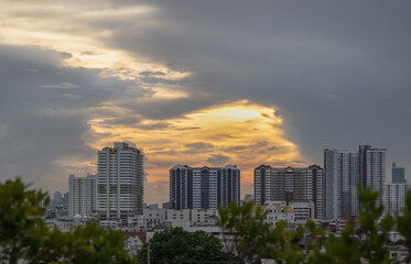 Fototapeta premium Gorgeous scenic of sunset with beautiful cloud and sky over metropolitan city. Bangkok city skyscrapers after sunset with Beautiful sky background, They can be used as Wallpaper, Copy space, Selective