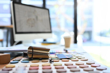 Interior designer at workstation with color swatches and material sample