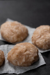 Frozen chicken meat cutlets on dark black background, semi-finished, ready for cooking. Convenience and homemade frozen healthy meals.