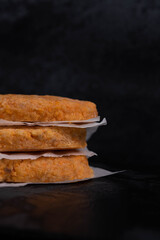 Frozen fish cutlets on dark black background, semi-finished, ready for cooking. Convenience and homemade frozen healthy meals.