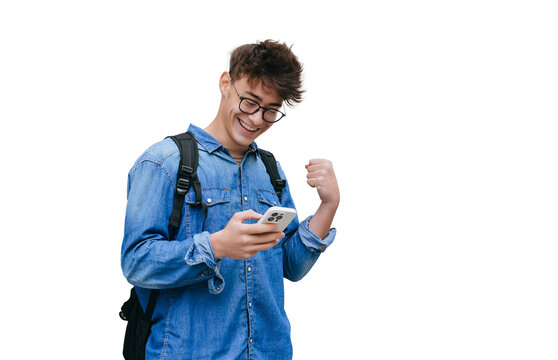 Grateful smart teen boy in jeans shirt received great News  in message smiles clenches fist like winner excited by passed exams against transparent background. Mockup, success, happy people.