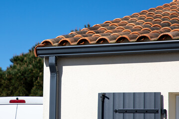 grey gutter guard system roof drip edge on modern home gray neighborhood