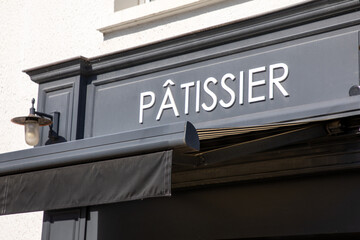 patissier text french and sign on shop facade means pastry entrance boutique in france