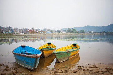 Colorful Canoes Reflect on Glass water in South East Asia Nepal