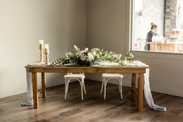 Wooden table with floral centerpiece and candles