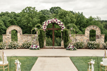 Floral wedding arch at an elegant outdoor ceremony