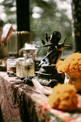 Home comfort, cozy atmosphere, flowers in a vase, Ganesha figures.