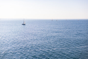 Sailboats on Lake Garda, Italy, under a clear sky