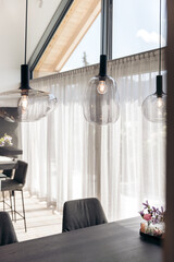 Modern dining area with glass pendant lights and floral decor