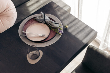Elegant table setting with plates and flower on a black table