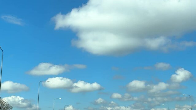 Motorway M62 driving directions Liverpool, Southport, Aintree, Warrington. Looking up through moving car windscreen.
