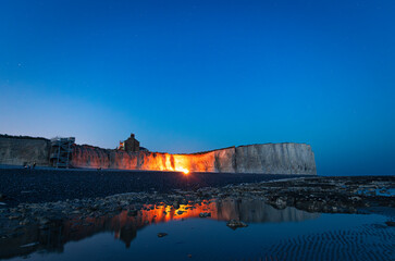 Starry night and beach bonfires at low tide Birling Gap east Sussex south east England UK