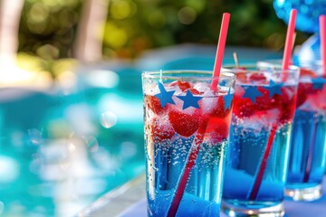 Festive beverages served at a pool party, featuring red, white, and blue layered drinks adorned with star-shaped decorations and straws. The drinks are set against a backdrop of a sparkling pool.