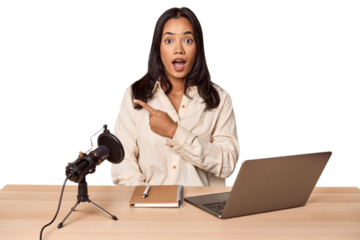 Woman records podcast with laptop pointing to the side