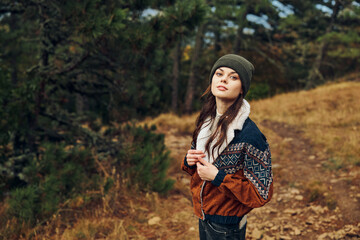 A Young Woman Embarking on a Stylish Adventure Through the Enchanting Forest Path in a Trendy Hat and Jacket