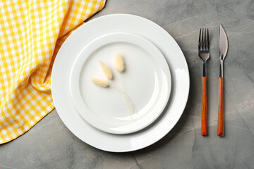 Empty plate with fork and knife on table