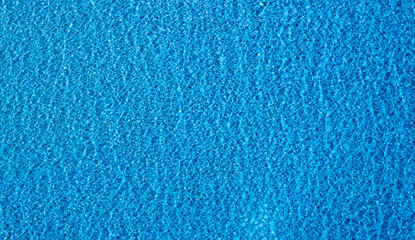 Top view summer sea water blue surface Clear water with ripples and foam. The sunlight shone...