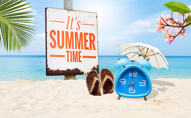 It's summer time sign with alram clock on tropical beach, summer outdoor day light