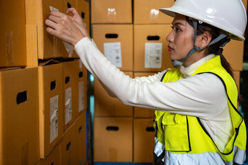 Beautiful Asian woman is sticking sticker bar code on cardboard box, Warehouse, Logistics, Import,...