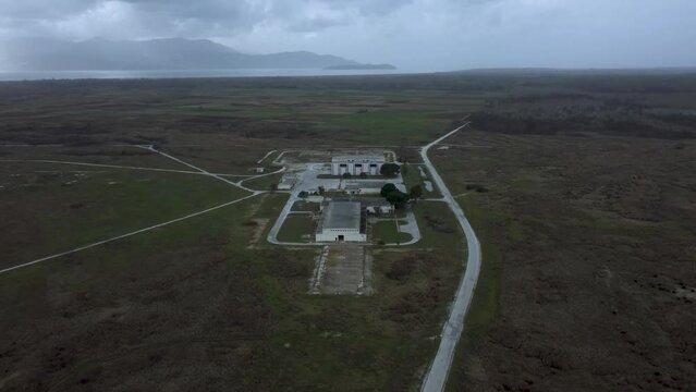 Drone establishing shot of abandoned military base and Voice of America radio station headquarters in Greece