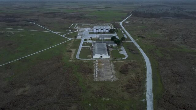 Aerial establishing reveal of abandoned military base and Voice of America radio station headquarters in Greece