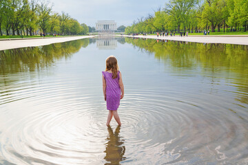  A girl tourist on Lincoln memorial and pool in Washington DC, USA